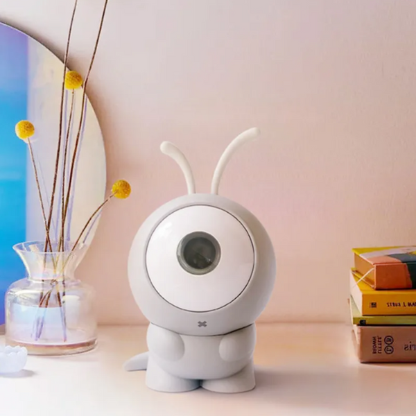 White MAYKQ Galaxy Projector on a modern bedside table